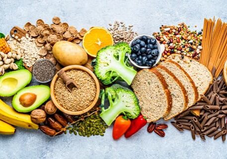 An assortment of healthy foods including fruits, vegetables, grains, and nuts.